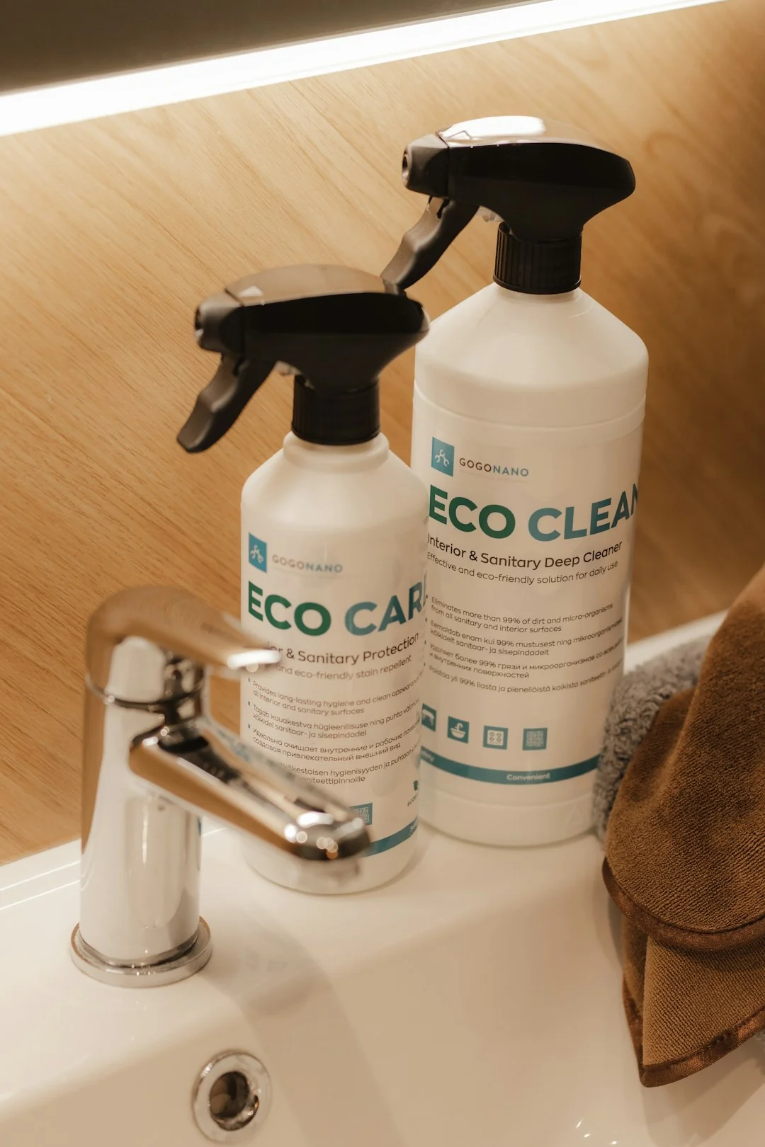 who-we-are A housekeeper gracefully straightens bed linens in a luxurious hotel room, demonstrating hospitality expertise.